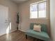 Charming entryway featuring a stylish bench seat, coat rack, and a bright window for a welcoming first impression at 26960 E Costilla Dr, Aurora, CO 80016