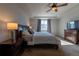 A spacious main bedroom showcasing a tray ceiling and a window view at 26960 E Costilla Dr, Aurora, CO 80016