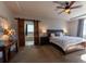 Bright main bedroom featuring a ceiling fan and a sliding barn door that opens to a soaking tub at 26960 E Costilla Dr, Aurora, CO 80016