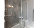 Tiled shower with a glass door and a built-in bench at 26960 E Costilla Dr, Aurora, CO 80016