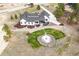 Aerial view showcasing the modern farmhouse, landscaping, fire pit and driveway at 1567 Arrowpoint Ct, Franktown, CO 80116