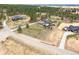 An aerial view of a home with a long driveway, nestled amongst trees in a picturesque setting at 1567 Arrowpoint Ct, Franktown, CO 80116