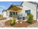 Backyard patio featuring hot tub, covered seating area, and professional landscaping at 1567 Arrowpoint Ct, Franktown, CO 80116