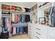 Spacious walk-in closet with custom shelving, drawers, and ample storage for clothing and accessories at 1567 Arrowpoint Ct, Franktown, CO 80116