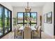 Bright dining room with a large window, stylish lighting, and seating for eight at 1567 Arrowpoint Ct, Franktown, CO 80116