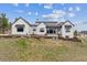 Attractive modern farmhouse with board and batten siding, stone details, and professional landscaping at 1567 Arrowpoint Ct, Franktown, CO 80116