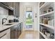 Charming kitchen with ample counter space, pantry shelves, and a view to the outdoors at 1567 Arrowpoint Ct, Franktown, CO 80116