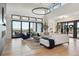 Well-lit living room with comfortable seating, stylish decor, and large windows offering scenic views at 1567 Arrowpoint Ct, Franktown, CO 80116