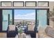 Bright living room with comfortable seating, a view to the outdoor space with a picnic table, and scenic views at 1567 Arrowpoint Ct, Franktown, CO 80116