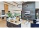 Open-concept living area with modern finishes, including wood beams, a fireplace and luxury vinyl plank flooring at 1567 Arrowpoint Ct, Franktown, CO 80116