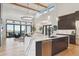 Spacious living room with island, modern finishes, hardwood floors, and abundant natural light at 1567 Arrowpoint Ct, Franktown, CO 80116