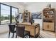 Bright home office featuring a large window with a view, a desk, and built-in shelving at 1567 Arrowpoint Ct, Franktown, CO 80116