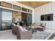 Covered patio featuring comfortable seating and an outdoor television for entertaining at 1567 Arrowpoint Ct, Franktown, CO 80116