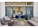 Inviting covered patio with plush seating overlooks a kitchen and living space for seamless indoor-outdoor living at 1567 Arrowpoint Ct, Franktown, CO 80116