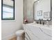 Stylish powder room with decorative wallpaper, stone countertop, framed art, and modern fixtures at 1567 Arrowpoint Ct, Franktown, CO 80116