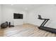 Well-lit workout room equipped with treadmill, weights and TV at 1567 Arrowpoint Ct, Franktown, CO 80116