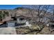 Charming exterior of a home with a two-car garage, landscaped yard, and backdrop of a large hill at 1003 N Jackson St, Golden, CO 80403