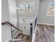 Bright foyer features a modern chandelier, wood-look floors, and contemporary railings at 1003 N Jackson St, Golden, CO 80403