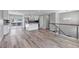 Open-concept living space featuring a modern kitchen, wood-look floors, and bright natural light at 1003 N Jackson St, Golden, CO 80403