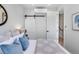 Bedroom with barn door, light bedding and blue pillows at 4391 Zenobia St, Denver, CO 80212