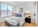 Bright bedroom with queen bed, round mirror and light wood floors at 4391 Zenobia St, Denver, CO 80212