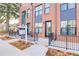 Townhouse exterior with brick facade and small patio at 4391 Zenobia St, Denver, CO 80212