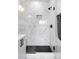 Modern shower with marble tile and black accents at 4391 Zenobia St, Denver, CO 80212