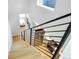 Modern light-wood staircase with metal railing and open view at 4391 Zenobia St, Denver, CO 80212