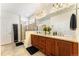 Well-lit bathroom featuring a double sink vanity with wood cabinets, a large mirror, and a glass-enclosed shower at 19780 W 57Th Ln, Golden, CO 80403