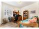 Cozy bedroom doubling as a home office, featuring a twin bed, desk, bookcase, and bright window light at 19780 W 57Th Ln, Golden, CO 80403