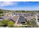 Exterior aerial view of modern homes with a backdrop of rolling hills under a bright, blue sky at 19780 W 57Th Ln, Golden, CO 80403