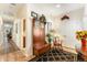 Inviting hallway with a wooden bench, a coat rack, a mirror, and connections to the kitchen and entryway at 19780 W 57Th Ln, Golden, CO 80403