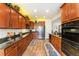 Spacious kitchen with stainless steel appliances, granite counters and warm wood cabinetry at 19780 W 57Th Ln, Golden, CO 80403
