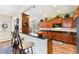 Open kitchen featuring wooden cabinets, a breakfast bar and granite countertops at 19780 W 57Th Ln, Golden, CO 80403