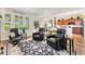 Comfortable living room featuring black leather recliner chairs, a decorative rug, and bright, natural lighting through large windows at 19780 W 57Th Ln, Golden, CO 80403