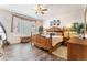 Spacious main bedroom featuring a wooden bed frame, side tables, lamps, and a window with a beautiful curtain at 19780 W 57Th Ln, Golden, CO 80403