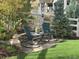 Inviting backyard with a stone patio, rocking chairs, and lush artificial turf at 1784 Cade Ave, Castle Rock, CO 80104