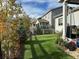 Manicured backyard with artificial turf, a patio area, and well-maintained landscaping at 1784 Cade Ave, Castle Rock, CO 80104