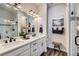 Modern bathroom with dual sinks, quartz countertops, and a glass-enclosed shower at 1784 Cade Ave, Castle Rock, CO 80104
