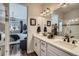 Elegant bathroom with dual sinks, quartz countertops, a glass-enclosed shower, and bedroom view at 1784 Cade Ave, Castle Rock, CO 80104