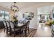 Dining room featuring modern chandelier and large dining table, open to the living area at 1784 Cade Ave, Castle Rock, CO 80104