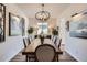 Elegant dining room with a large table, stylish chandelier, and ample natural light at 1784 Cade Ave, Castle Rock, CO 80104