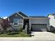 Charming single-Gathering home with a manicured lawn, gray stone accents, and an attached two-car garage at 1784 Cade Ave, Castle Rock, CO 80104