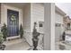Inviting front entrance with blue door, decorative wreath, and charming curb appeal with potted trees flanking the door at 1784 Cade Ave, Castle Rock, CO 80104