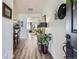 Entryway hallway with hardwood floors, console table, and art display, leading into the dining and living areas at 1784 Cade Ave, Castle Rock, CO 80104