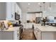 Well-lit kitchen featuring white cabinetry, stainless steel appliances, and a breakfast bar at 1784 Cade Ave, Castle Rock, CO 80104