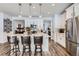 Bright, modern kitchen features white cabinetry, quartz countertops, stainless appliances, and pendant lighting at 1784 Cade Ave, Castle Rock, CO 80104