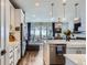 Open kitchen showcases a breakfast bar and stainless steel appliances, open to the living area at 1784 Cade Ave, Castle Rock, CO 80104