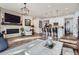 Spacious living room with a fireplace, large windows, and an open layout to the kitchen at 1784 Cade Ave, Castle Rock, CO 80104