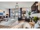 Bright living room featuring hardwood floors, stylish furniture, and a sliding glass door to the outdoor area at 1784 Cade Ave, Castle Rock, CO 80104